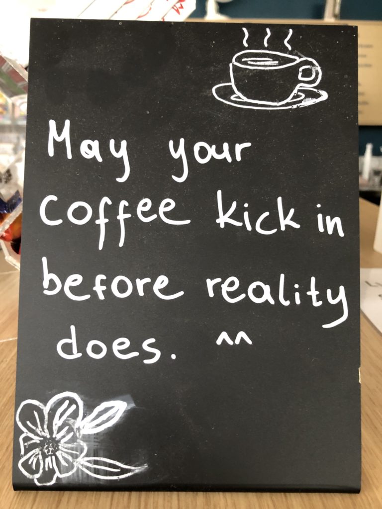 Sign that says may your coffee kick in before reality found in a cafe in Iceland most likely Reykjavik  